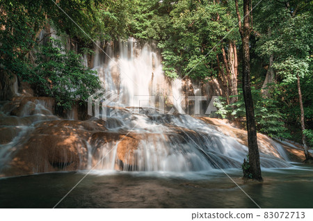 Sai Yok Noi waterfall flowing on limestone in tropical rainforest at national park 83072713