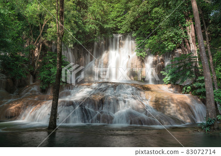 Sai Yok Noi waterfall flowing on limestone in tropical rainforest at national park 83072714