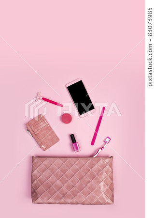 Top view of woman bag and lady things with copyspace on pink background Top view of woman bag and lady things with copyspace on pink background 83073985