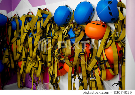 Helmets and climbing equipment hanging on the wall Helmets and climbing equipment hanging on the wall 83074039