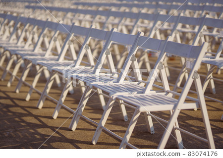 Rows of concert chairs for viewers on the street 83074176