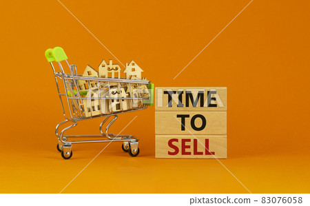 Time to sell real estate symbol. Wooden blocks, words 'time to sell' on beautiful orange background. Shopping cart with miniature wooden houses. Business, time to sell real estate concept. Copy space. Time to sell real estate symbol. Wooden blocks, words 'time to sell' on beautiful orange background. Shopping cart with miniature wooden houses. Business, time to sell real estate concept. Copy space. 83076058