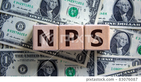Wood cubes with acronym 'NPS' - 'net promoter score' on a beautiful background from dollar bills. Business concept, copy space. Wood cubes with acronym 'NPS' - 'net promoter score' on a beautiful background from dollar bills. Business concept, copy space. 83076087