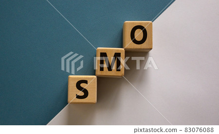 SMO symbol. Wooden cubes with word 'SMO - social media optimization' stacking as step stair on paper blue and white background, copy space. Business and SMO concept. SMO symbol. Wooden cubes with word 'SMO - social media optimization' stacking as step stair on paper blue and white background, copy space. Business and SMO concept. 83076088