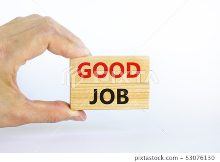 Good job symbol. Concept words 'good job' on wooden blocks on a beautiful white background. Businessman hand. Business and good job concept, copy space. 83076130