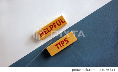 Helpful tips symbol. Wooden blocks with words 'Helpful tips'. Beautiful white and blue background. Business and helpful tips concept. Copy space. Helpful tips symbol. Wooden blocks with words 'Helpful tips'. Beautiful white and blue background. Business and helpful tips concept. Copy space. 83076134