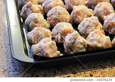 view of raw turkey pine nut meatballs on cookie sheets view of raw turkey pine nut meatballs on cookie sheets 83076226