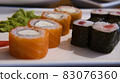 rolls with red fish on a plate 83076360
