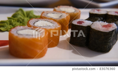 rolls with red fish on a plate rolls with red fish on a plate 83076360