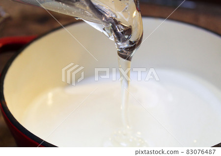 Pouring Clear Thick Liquid into a Pot 83076487