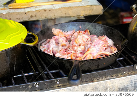 Closeup of bacon frying in a pan Closeup of bacon frying in a pan 83076509