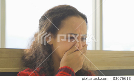 Depressed lonely sad emotional business latin woman is fired from job, crying. Sitting on bed in bedroom at home in early morning. Quarantine lifestyle. Unhappy life. 83076618