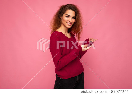 Photo of young happy positive smiling beautiful brunette wavy woman with sincere emotions wearing 83077245
