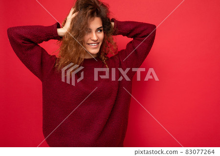 Shot of attractive happy smiling young woman wearing casual outfit standing isolated over colourful Shot of attractive happy smiling young woman wearing casual outfit standing isolated over colourful 83077264