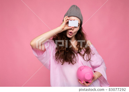 Beautiful amazed surprised young brunette woman wearing shirt isolated on pink background with free Beautiful amazed surprised young brunette woman wearing shirt isolated on pink background with free 83077292