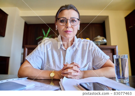 Female psychologist, psychiatrist in headphones looking at webcam, closeup face Female psychologist, psychiatrist in headphones looking at webcam, closeup face 83077463