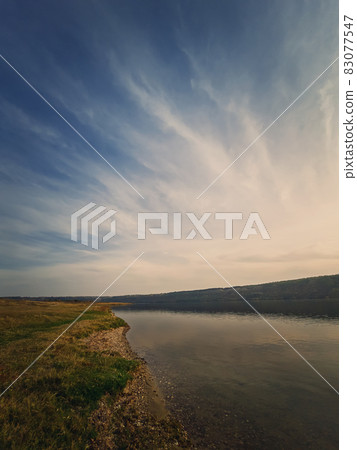 Scenic view to the riverbank of Nistru river, Moldova. Vertical background, calm water flowing. Natural landscape, silent empty place Scenic view to the riverbank of Nistru river, Moldova. Vertical background, calm water flowing. Natural landscape, silent empty place 83077547