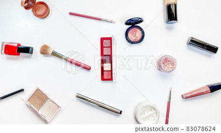 Beauty concept. Makeup products shadows, highlighter, blush, brushes, powder, glitter, mascara, gloss, lipstick, pencil on white background 83078624