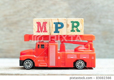 Fire ladder truck hold letter block in word MPR (Abbreviation of Market price referent or Monthly progress report) on wood background 83081566