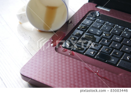 coffee spilling on laptop keyboard. close up  83083446