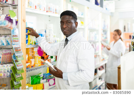Pharmacists putting drug packages in order 83085890