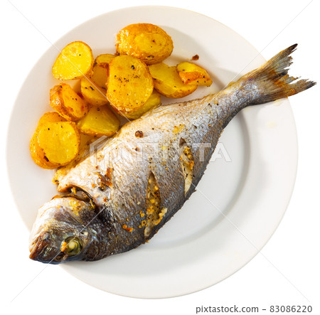 Baked dorado with potatoes on plate Baked dorado with potatoes on plate 83086220