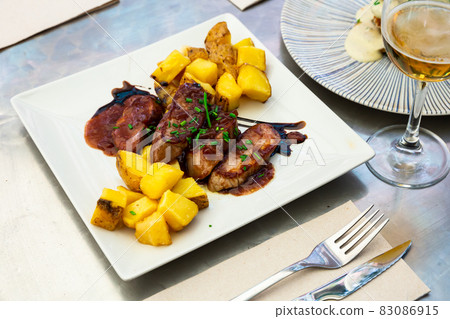 Baked sirloin medallion with potato at white plate 83086915