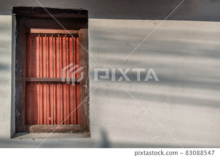 Brick Concrete wall white grey color and wooden window in an ancient temple. Brick Concrete wall white grey color and wooden window in an ancient temple. 83088547