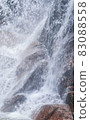 Waterfalls and splashes hitting rocks 83088558
