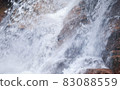 Waterfalls and splashes hitting rocks 83088559