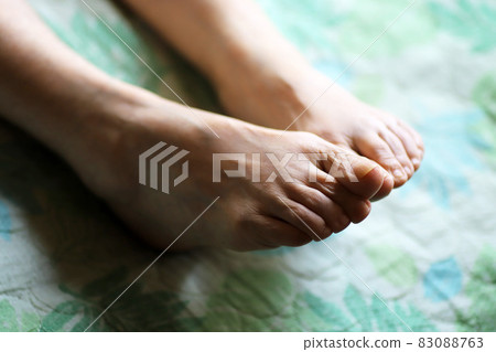 Up the feet of an elderly woman lying on a nursing bed Up the feet of an elderly woman lying on a nursing bed 83088763