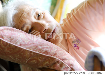 Elderly woman reclining in a nursing bed and lying down 83089087