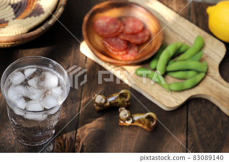 Cold chilled highballs poured into a glass, salami and edamame snacks Cold chilled highballs poured into a glass, salami and edamame snacks 83089140
