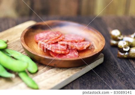 Salami and edamame snacks on a small plate Salami and edamame snacks on a small plate 83089141
