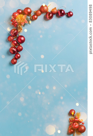 Christmas decorations red New Year's balls lined with a frame on a blue background with snowflakes, sparkles, confetti 83089498
