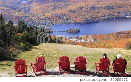 Aerial view of Mont Tremblant Lake with autumn color leaf and red chairs on the foreground, Quebec, Canada 83089972