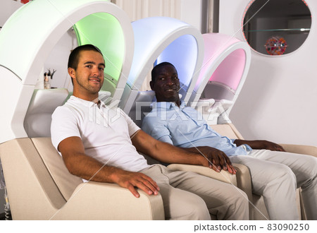 Male clients sitting in armchairs for washing hair 83090250