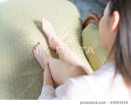 A neat woman doing a foot massage A neat woman doing a foot massage 83091634