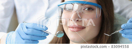 Portrait of beautiful woman at dentist appointment Portrait of beautiful woman at dentist appointment 83094558