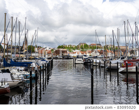 Sail boats in the port of Flensburg, St. Jorgen's Church in the background. Schleswig-Holstein in Germany Sail boats in the port of Flensburg, St. Jorgen's Church in the background. Schleswig-Holstein in Germany 83095020