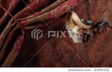 Old masquerade Venetian carnival mask with feathers and rhinestones. Old masquerade Venetian carnival mask with feathers and rhinestones. 83095302