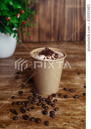 Drawings on coffee. Male and female cappuccino decoration. Hot drink in a paper cup. Picture of a chocolate mountain and Japanese cherry blossom. Food industry creativity concept Drawings on coffee. Male and female cappuccino decoration. Hot drink in a paper cup. Picture of a chocolate mountain and Japanese cherry blossom. Food industry creativity concept 83095865