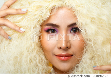 Half Body Portrait of 20s Asian Caucasian beautiful Woman blonde afro hair high fashion make up 83096328
