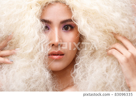 Half Body Portrait of 20s Asian Caucasian beautiful Woman blonde afro hair high fashion make up 83096335