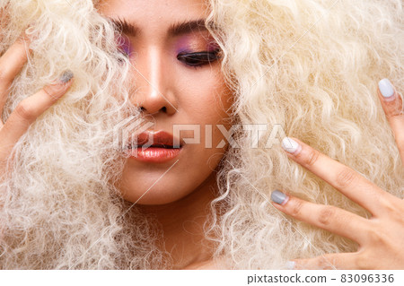 Half Body Portrait of 20s Asian Caucasian beautiful Woman blonde afro hair high fashion make up Half Body Portrait of 20s Asian Caucasian beautiful Woman blonde afro hair high fashion make up 83096336
