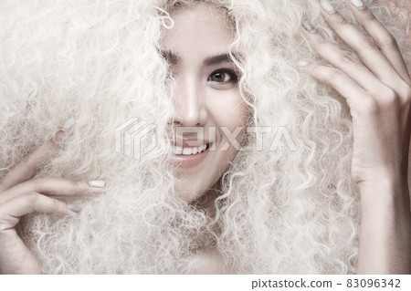 Half Body Portrait of 20s Asian Caucasian beautiful Woman blonde afro hair high fashion make up Half Body Portrait of 20s Asian Caucasian beautiful Woman blonde afro hair high fashion make up 83096342
