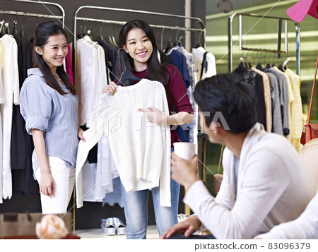 young asian women choosing clothes in a clothing shop or department store young asian women choosing clothes in a clothing shop or department store 83096379