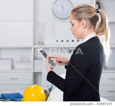 Businesswoman using phone in design office Businesswoman using phone in design office 83097155