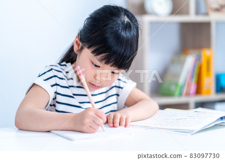 Elementary school girl doing homework 83097730