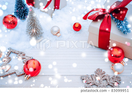 Table wood Christmas. Xmas board with old rustic wall, white frozen snow, golden balls and gift box. Winter wooden decoration background. Happy new year copy space. Table wood Christmas. Xmas board with old rustic wall, white frozen snow, golden balls and gift box. Winter wooden decoration background. Happy new year copy space. 83099951